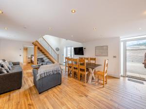 a living room with a table and a dining room at Ty Godro - Uk12745 in Acrefair