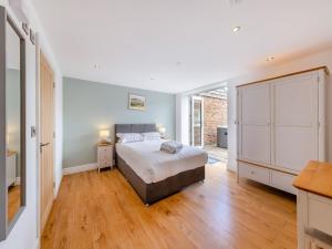 a bedroom with a bed and a large window at Ty Godro - Uk12745 in Acrefair