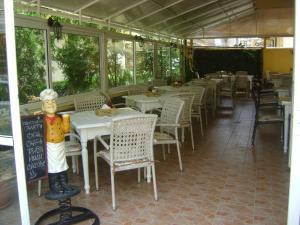 a restaurant with a statue of a man sitting at a table at Family Hotel Diana in Pomorie
