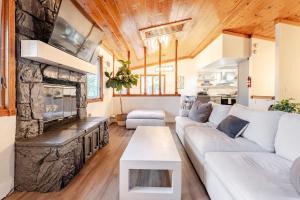 a living room with a couch and a fireplace at Sleeps 10 Cozy Modern Cabin- 5 minutes to lake, fishing, & hiking in Crestline