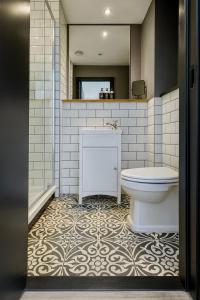 a bathroom with a toilet and a sink and a mirror at Canal Side Luxury Apartment in Leeds City Centre Sleeps 3 in Leeds +21 photos