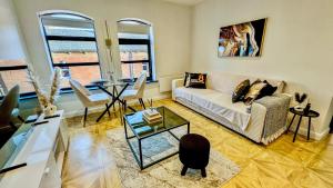 a living room with a couch and a table at Canal Side Luxury Apartment in Leeds City Centre Sleeps 3 in Leeds