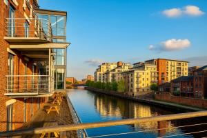 a view of a river in a city with buildings at Canal Side Luxury Apartment in Leeds City Centre Sleeps 3 in Leeds