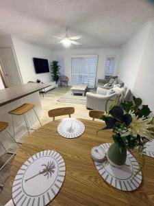 a living room with a table with plates on it at Oceanside Cove in Gold Coast
