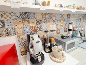 a kitchen with a mixer on a counter with tiles at B&B Alle porte del centro in Santa Maria Capua Vetere