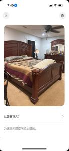a bedroom with a large wooden bed in a room at Sweet home in Phenix City