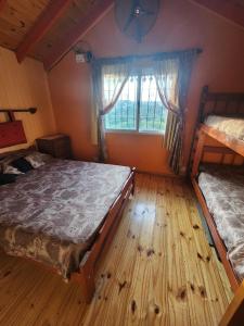 a bedroom with two bunk beds and a window at Cabañas Dulce Atardecer in Villa Carlos Paz +63 photos