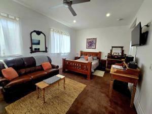 a living room with a couch and a bed at Contemporary Studio Accommodation in Farrell Flat +1 photo