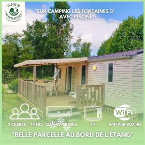 a mobile home with a porch and a gazebo at Mobilhomes Cozy 2 ou 3 chambres en bordure d'étang Camping 3 étoiles in Ivry-la-Bataille