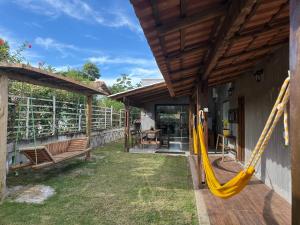 a patio with a yellow hammock on a house at Casa de Pedras in Prado