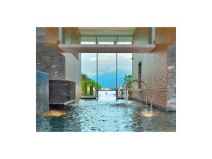 a swimming pool in a building with a view at 1-bedroom holiday apartment in Locarno