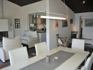 a kitchen and living room with a table and chairs at 1-bedroom holiday home in Ponte Brolla