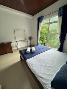 Ένα ή περισσότερα κρεβάτια σε δωμάτιο στο Seetha Homestay Kandy