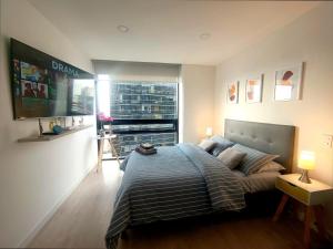 Ένα ή περισσότερα κρεβάτια σε δωμάτιο στο AH/Loft con Alexa, Parking, Coworking, Usaquén