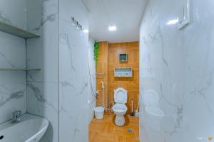 a bathroom with a white toilet and a sink at Ideal place to stay for 8-12pax with Parking Area in Mactan Island
