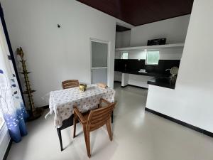 a dining room with a table and two chairs at Seetha Homestay Kandy in Kandy