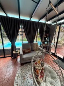 a swing in a living room with a pool at The Lil Luxe Tiny Homes Bangi - 2 Villa with 2 Private Pools in Bandar Baru Bangi