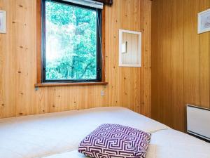 a bedroom with a bed and a window at 4 person holiday home in R m in Mølby