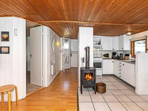 a kitchen with a stove in the middle of a room at 4 person holiday home in Thisted in Thisted +18 photos