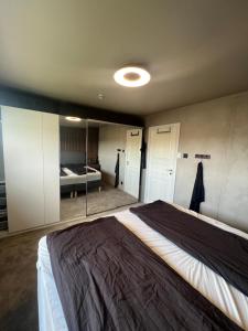 a bedroom with a large bed in a room at Sentral enebolig på Lura med Jacuzzi! in Stavanger