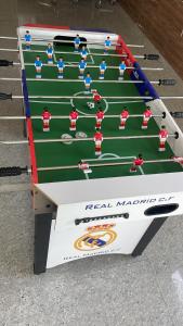 a table with a football game on it at Rocopie farm in Rohtak