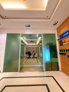 a lobby of a building with people in the background at Mansion One studio in George Town