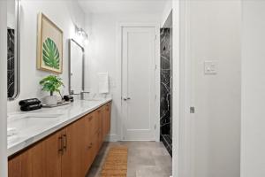 a white bathroom with a sink and a mirror at The Loftline in Dallas +34 photos