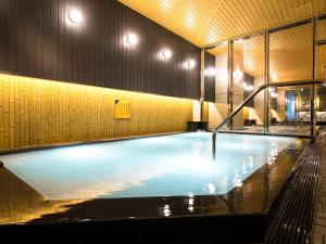 a large swimming pool in a building with lights on it at APA Hotel & Resort Osaka Namba Ekimae Tower in Osaka