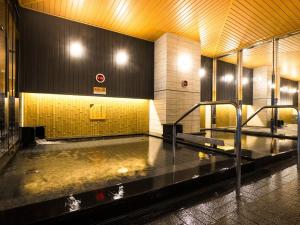 a room with a pool of water in a building at APA Hotel & Resort Osaka Namba Ekimae Tower in Osaka