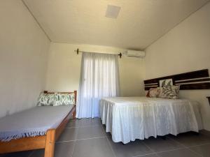 a bedroom with two beds and a window at Casa de Pedras in Prado +39 photos