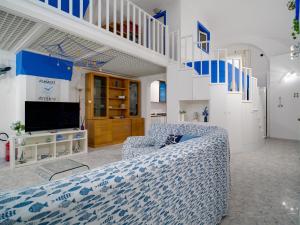 a living room with a couch and a staircase at Blue Atrani Central House - 150 mt dalla spiaggia in Atrani