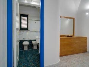a bathroom with a toilet and a sink and a mirror at Blue Atrani Central House - 150 mt dalla spiaggia in Atrani +28 photos