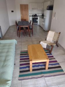 a living room with a wooden table and chairs at DEPARTAMENTO VILLA CARLOS PAZ CENTRO in Villa Carlos Paz
