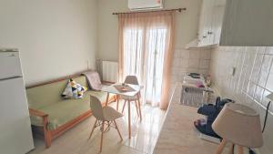 a kitchen with a couch and a table and chairs at Polyxeni's apartment in Kastoria