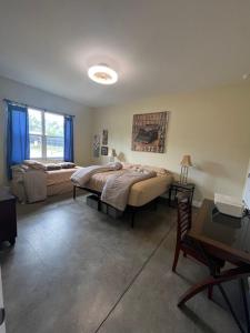 a bedroom with two beds and a table and a desk at Modern & Peaceful Retreat Near WEC & Ocala Amenities in Ocala