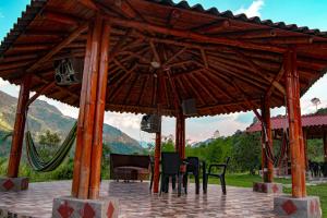 a wooden pavilion with a table and chairs under it at Quinta Maka VistaHermosa in Villeta +87 photos