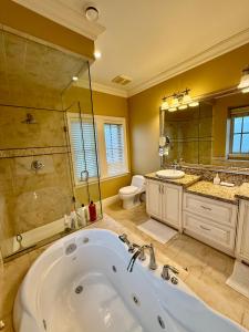 a bathroom with a tub and a shower and a toilet at Peaceful Retreat in Arbutus in Vancouver