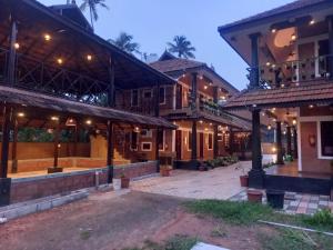 a courtyard of a building with many buildings at Credible Heritage Resort in Varkala