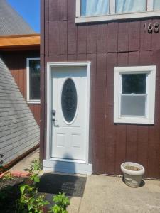 a white door on the side of a house at Charming 1-bdrm Apt close to all in Hamburg