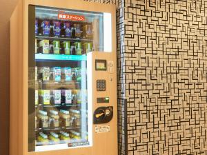 a vending machine filled with bottles of soda at APA Hotel & Resort Osaka Namba Ekimae Tower in Osaka