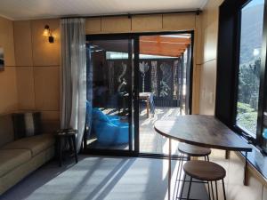 a living room with a table and a couch at Haven Cabin - No road access - just a boat ride away in Endeavour Inlet