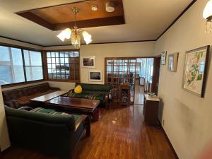 a living room with couches and a table at Kouan 功庵 in Matsuyama