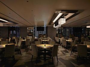 a dining room filled with tables and chairs at APA Hotel & Resort Osaka Namba Ekimae Tower in Osaka