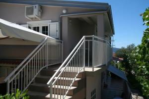 a house with stairs leading up to the backdoor at Apartments Soldo in Pinezici