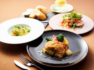 a table with plates of food on a table at APA Hotel & Resort Osaka Namba Ekimae Tower in Osaka