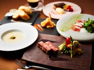 a table with plates of food on a table at APA Hotel & Resort Osaka Namba Ekimae Tower in Osaka
