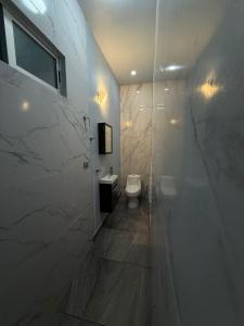 a white bathroom with a toilet and a shower at Villa los Encinos 