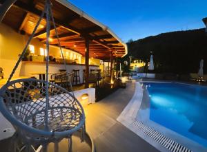 a house with a swimming pool on a roof at Lily's Guest House in Megali Ammos