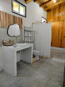 a bathroom with a white sink and a toilet at Hermosa Cabaña Familiar en Oaxaca in Oaxaca City +72 photos