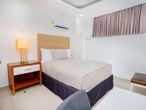 Postel nebo postele na pokoji v ubytování Muna Hotel